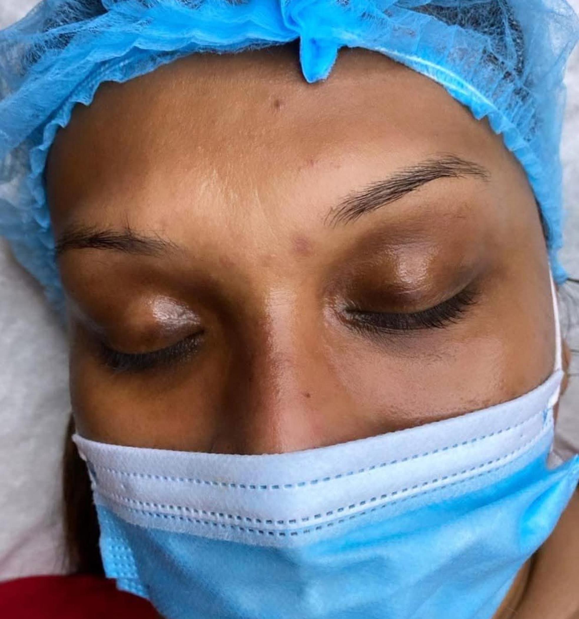 technician shaping eyebrows with microblading tools